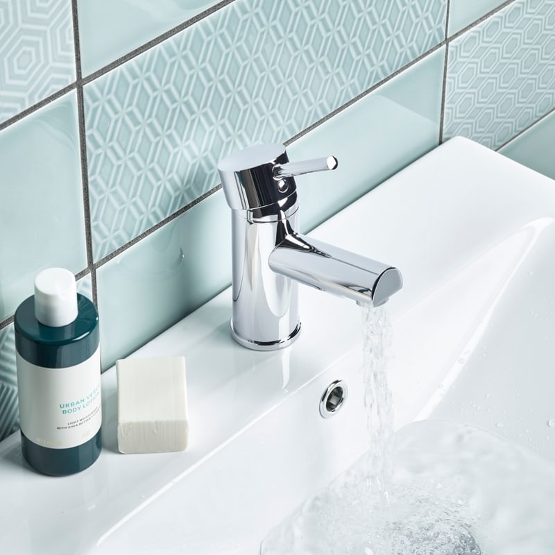 Joy basin mixer top lifestyle with water Joy basin mixer top lifestyle with water